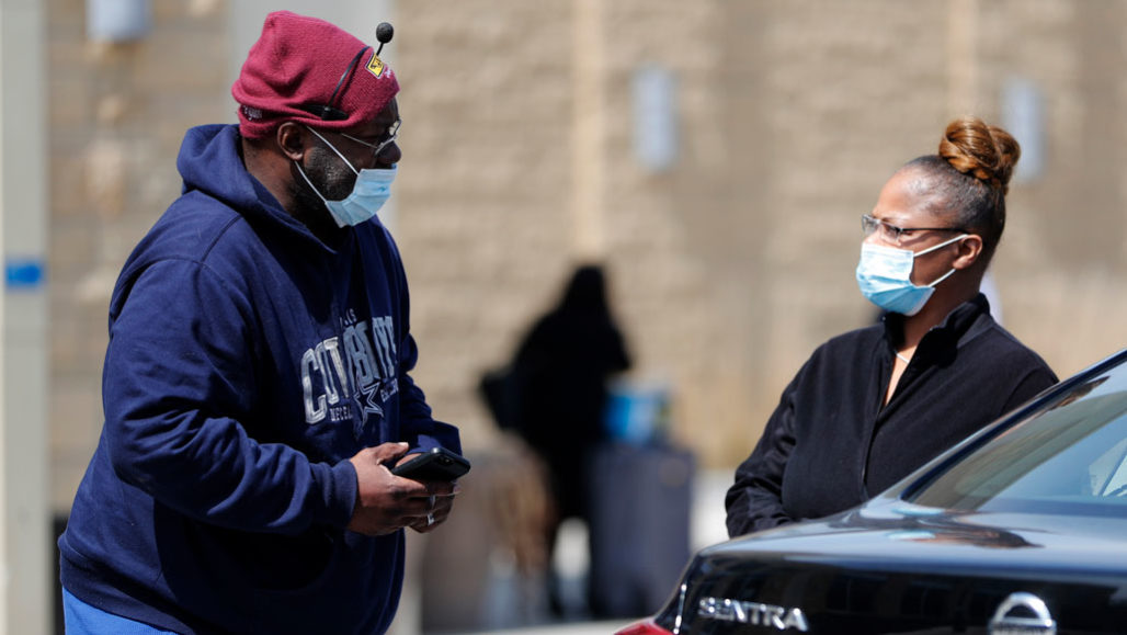 two people wearing masks