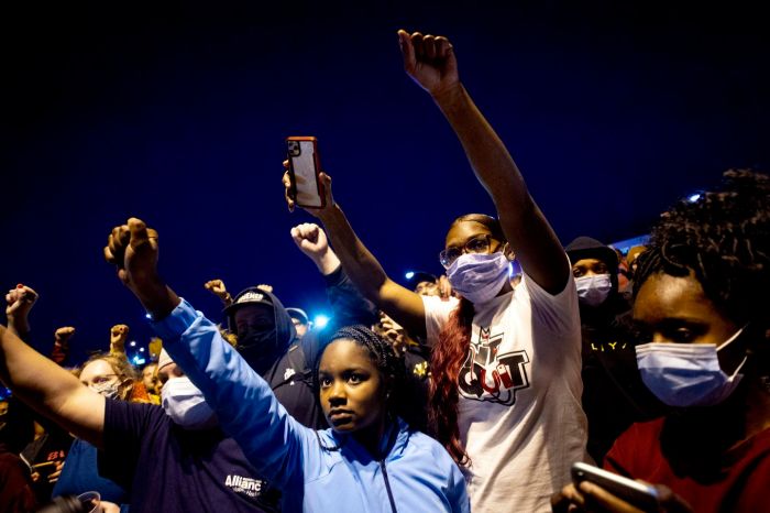 People march at a peaceful protest seeking justice for George Floyd in Flint Township, Michigan.