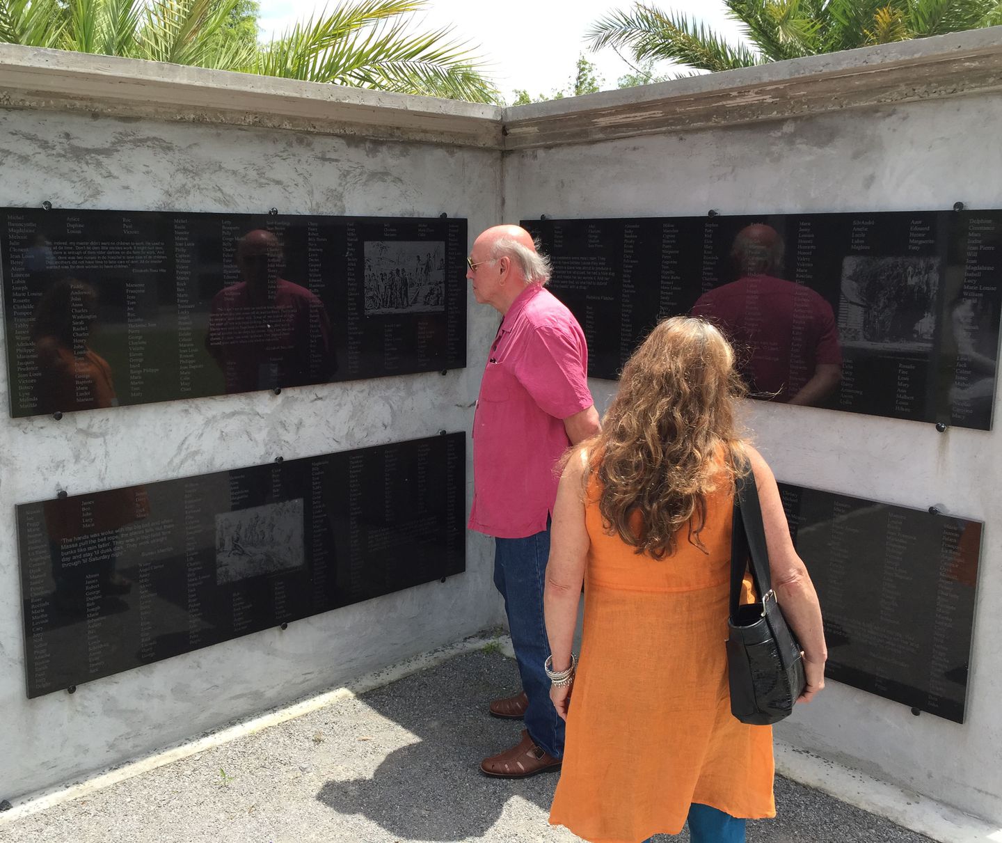 Jim Smith and Paula Barry of Conway, Mass., examined names of Louisiana slaves recorded on the 18 monument walls in the Allées Gwendolyn Midlo Hall at Whitney Plantation.