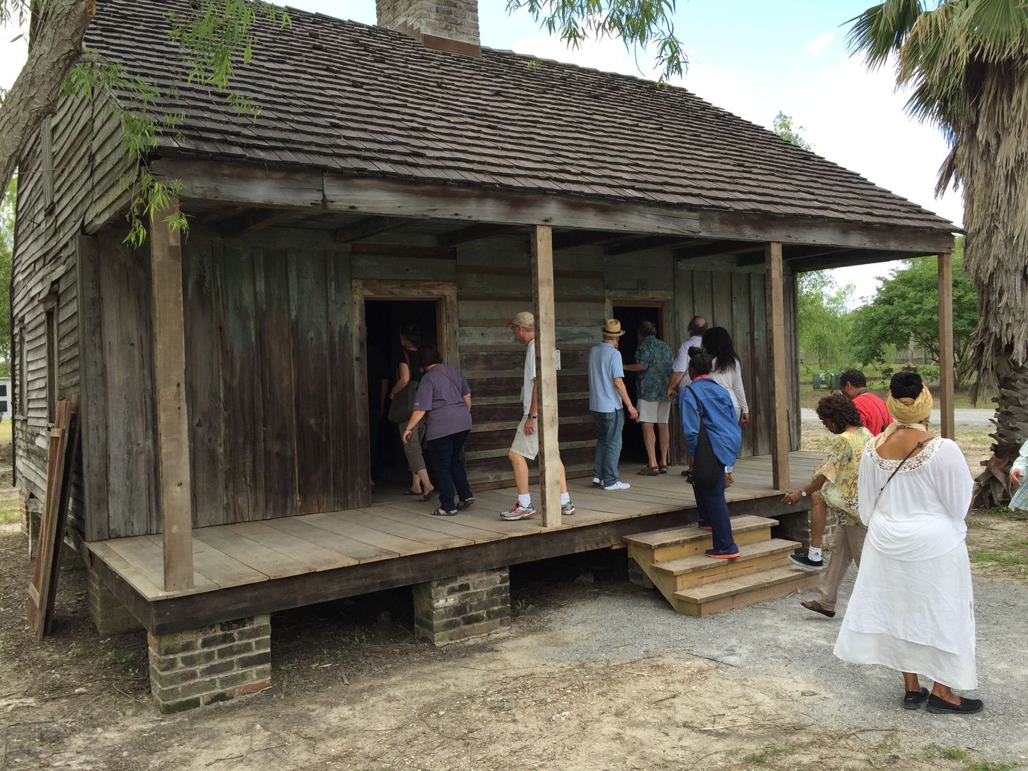 Visitors took a close look at a slave cabin at Whitney Plantation.